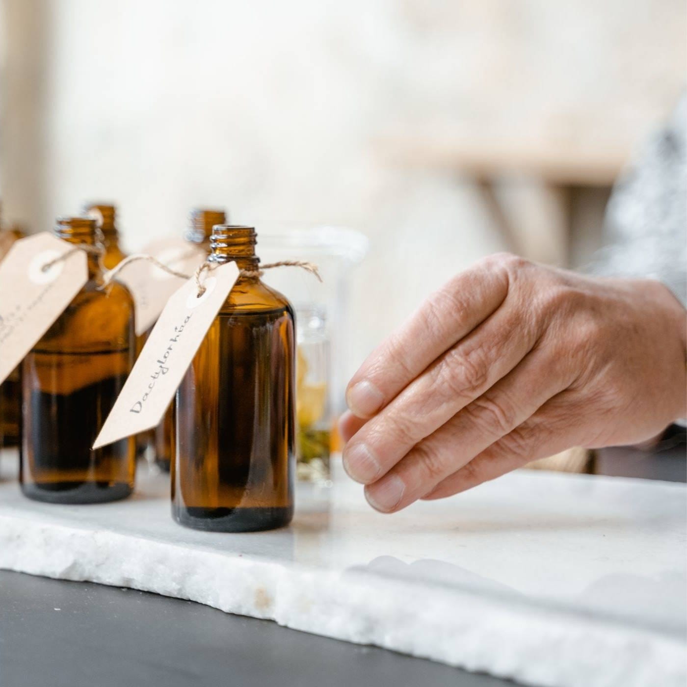 A skilled perfumer crafting luxurious fragrances at Luxaro, showcasing the art and expertise behind our premium perfumes made in Grasse, France