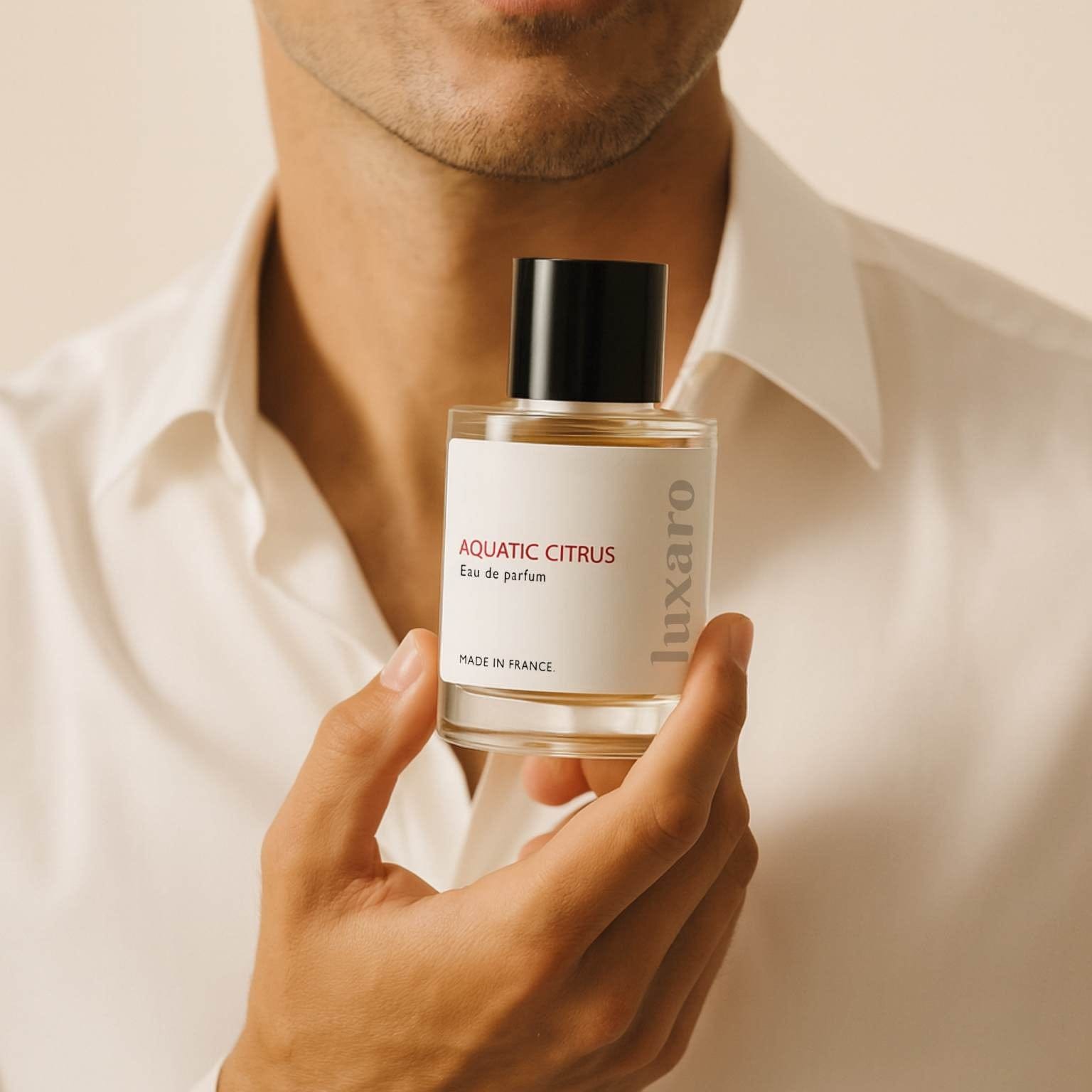 Person holding a Luxaro Aquatic Citrus designer inspired perfume bottle