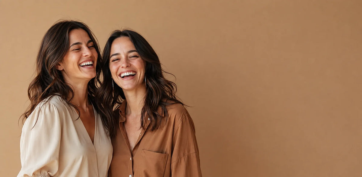 Two women smiling together for Luxaro Perfumes, a UK brand offering designer-inspired perfumes made in France.