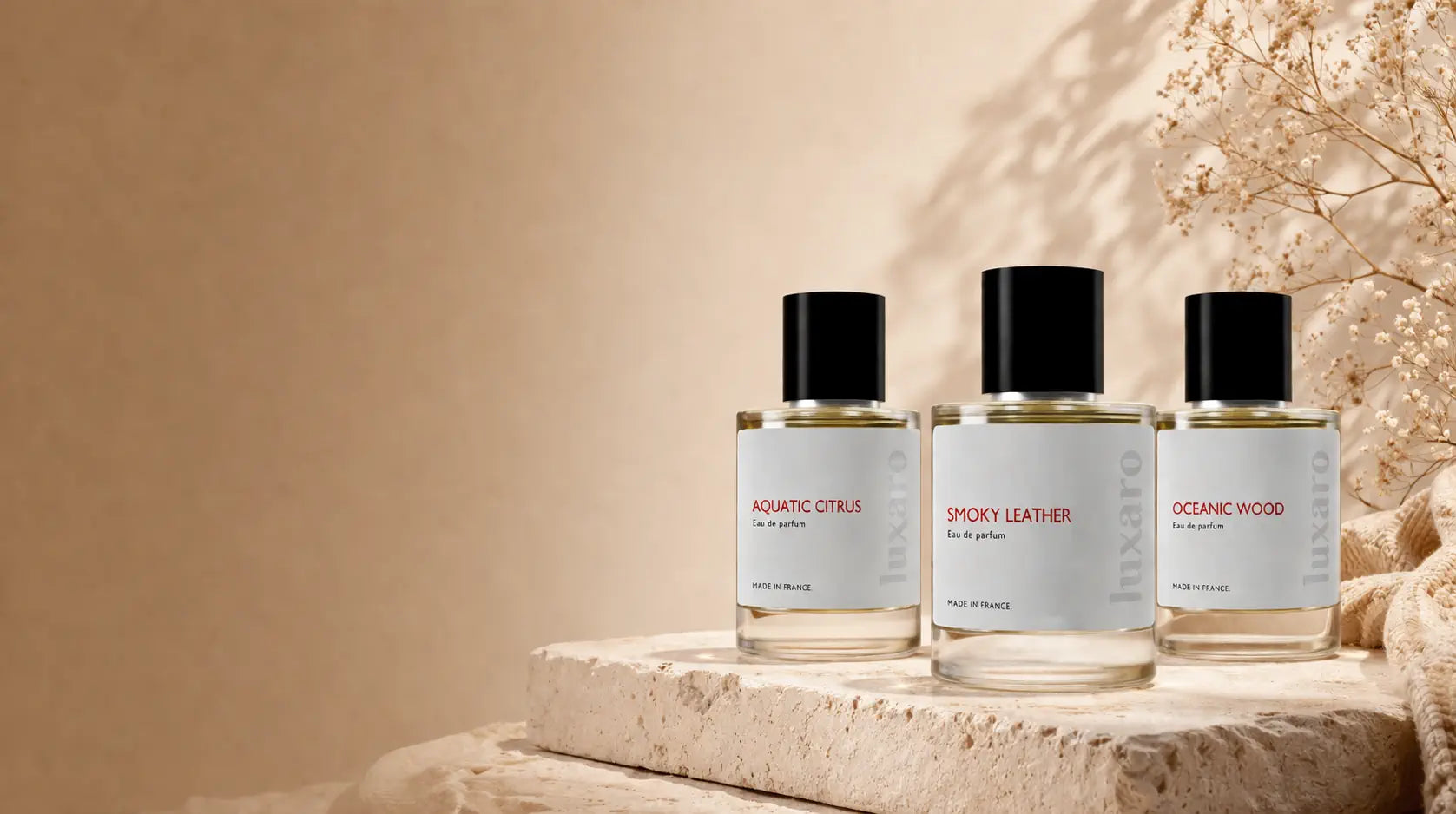 Luxury perfume bottles displayed on a stone surface with one elevated on a marble pedestal, set against a soft warm brown gradient background