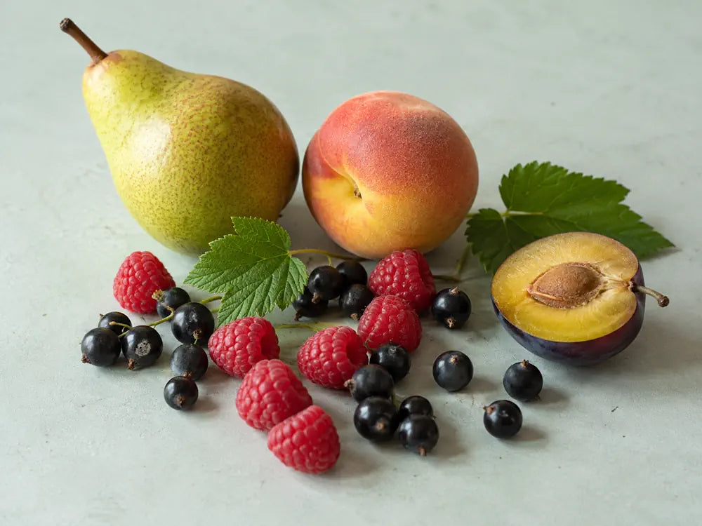 Pear, peach, raspberries, blackcurrants and plum representing a fruity accord in perfume