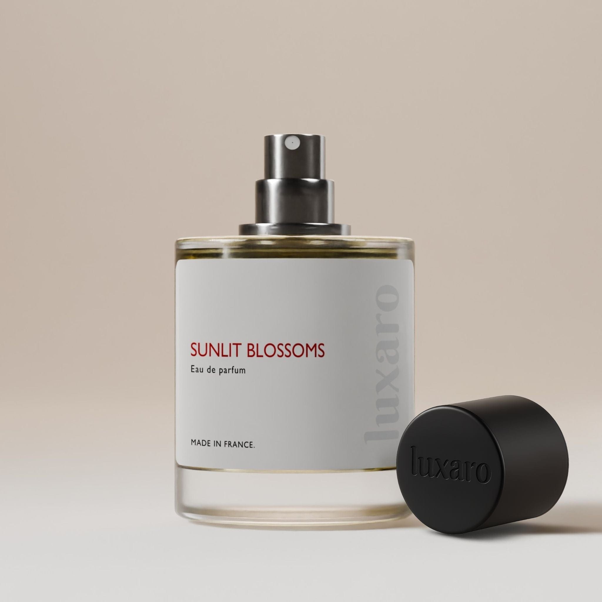 Luxaro Sunlit Blossoms perfume bottle with cap removed, revealing the captivating fragrance inside, inspired by Armani My Way dupe – featuring notes of orange blossom, tuberose, and vanilla, luxury fragrance alternative made in France.